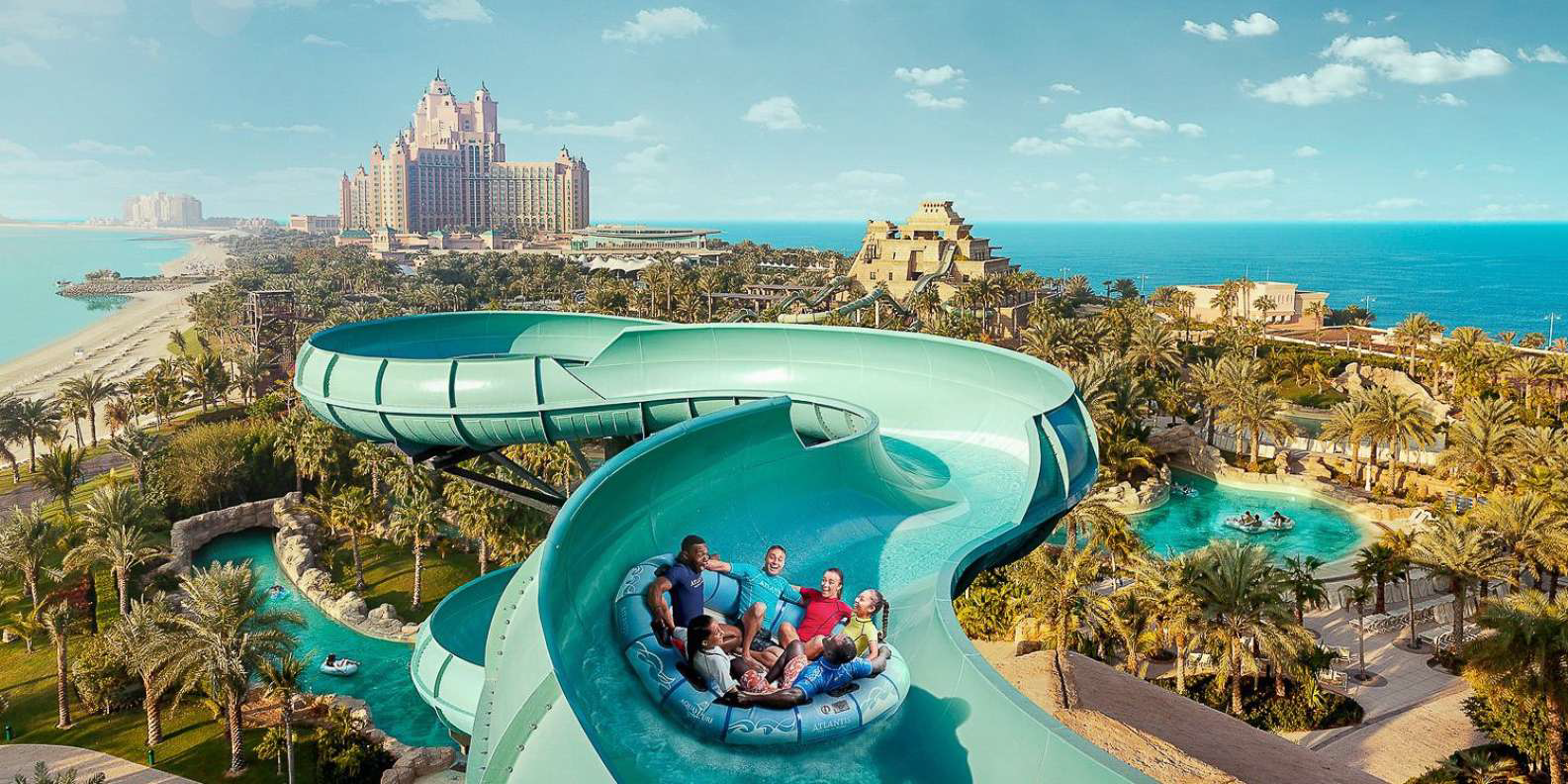 A group of people on a water slide  Description automatically generated